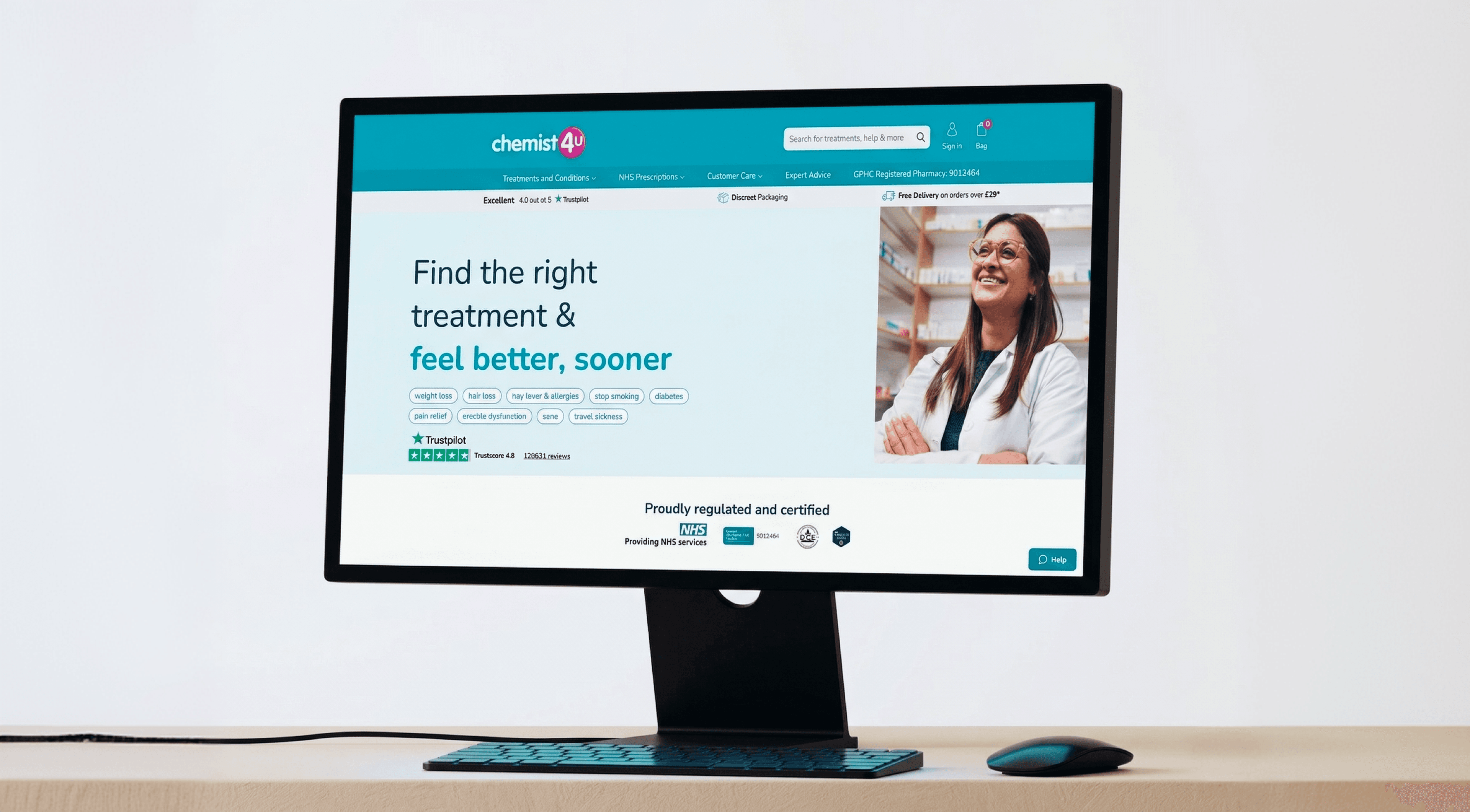 Computer monitor displaying Chemist4U homepage with a smiling pharmacist.