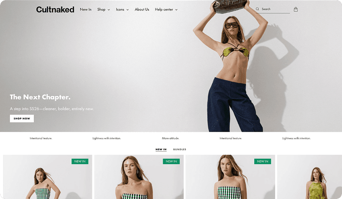Model in green bikini top and jeans, holding brown purse overhead.